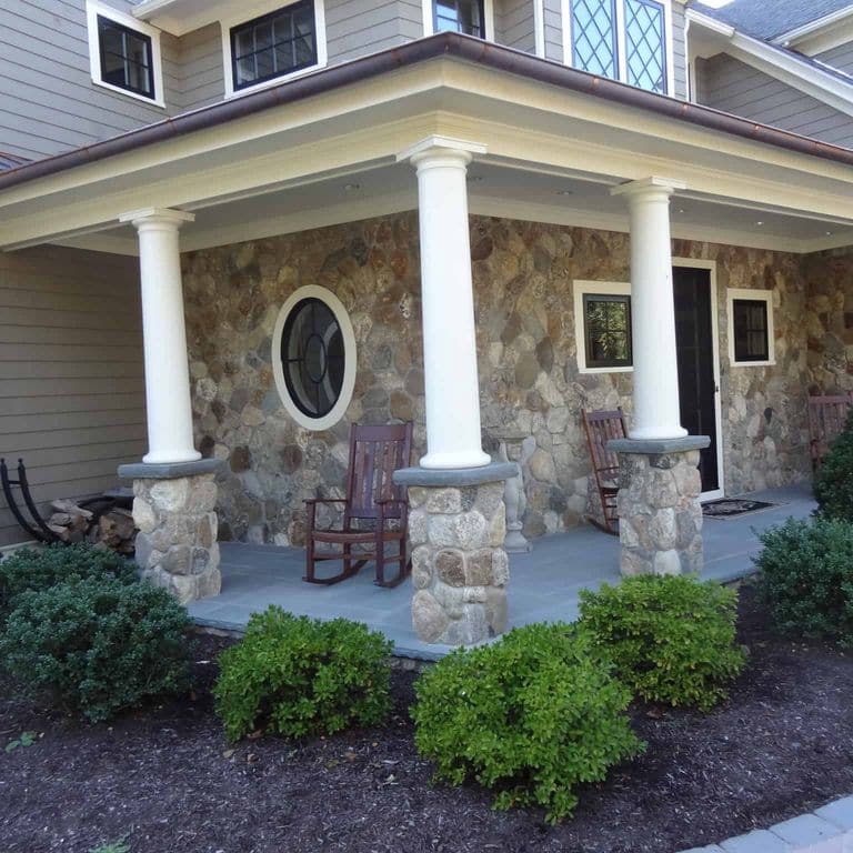 Application image for Boston Blend Granite Veneer - Rounds. The image shows this product being used in a full bed veneer application. The surface finish shown is . Dominant colors shown are gray and tan. The color mix creates a warm feeling.