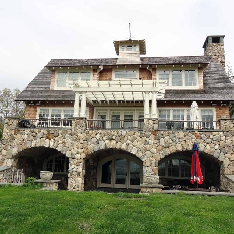Application image for Boston Blend Granite Veneer - Rounds. The image shows this product being used in a full bed veneer application. The surface finish shown is . The dominant color shown is gray. The color mix creates a warm feeling.