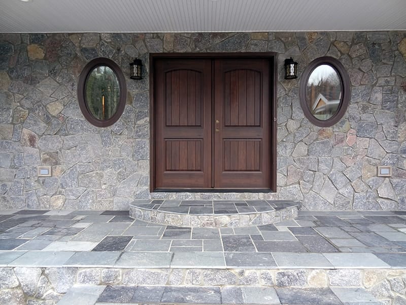 Application image for Vineyard Granite Veneer - Mosaic. The image shows this product being used in a full bed veneer application. The surface finish shown is . The dominant color shown is gray. The color mix creates a cool feeling.