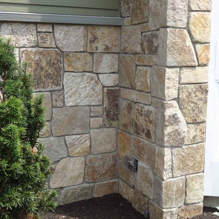 Application image for New England Tan Granite Veneer - Square and Rectangle. The image shows this product being used in a full bed veneer application. The surface finish shown is . Dominant colors shown are brown and tan. The color mix creates a warm feeling.