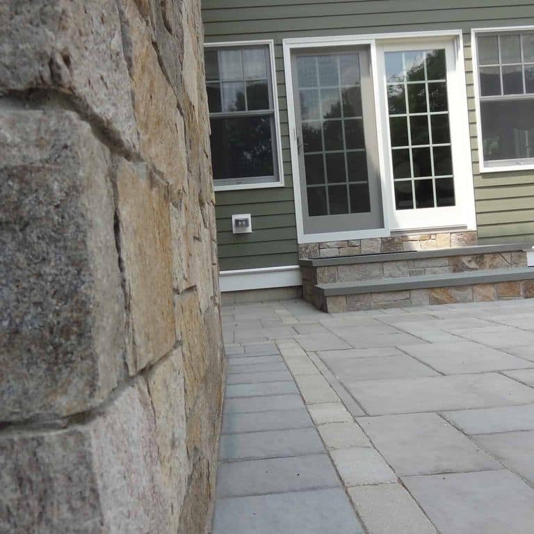 Application image for New England Tan Granite Veneer - Square and Rectangle. The image shows this product being used for fireplace surround, full bed veneer and thin veneer. The surface finish shown is . Dominant colors shown are gray and tan. The color mix creates a warm feeling.
