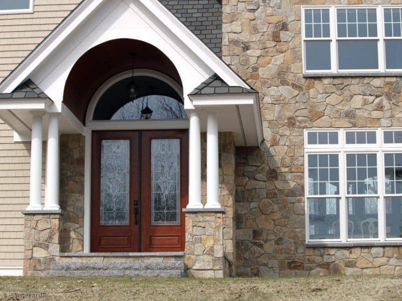Application image for New England Tan Granite Veneer - Mosaic. The image shows this product being used in a full bed veneer application. The surface finish shown is . Dominant colors shown are brown, gray and tan. The color mix creates a warm feeling.