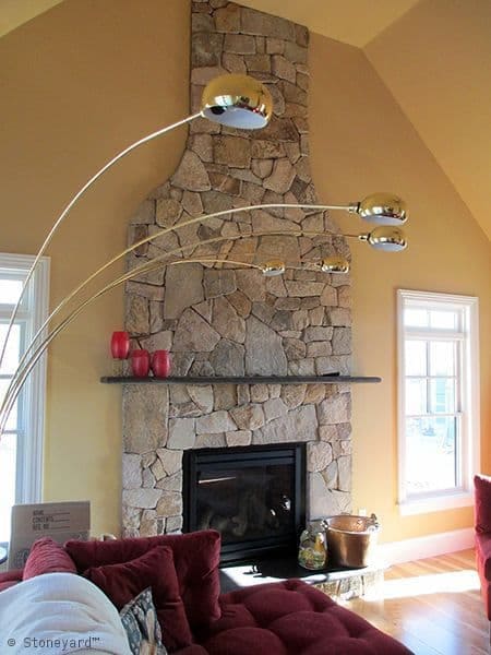 Application image for New England Tan Granite Veneer - Mosaic. The image shows this product being used for fireplace surround and full bed veneer. The surface finish shown is . Dominant colors shown are brown and tan. The color mix creates a warm feeling.