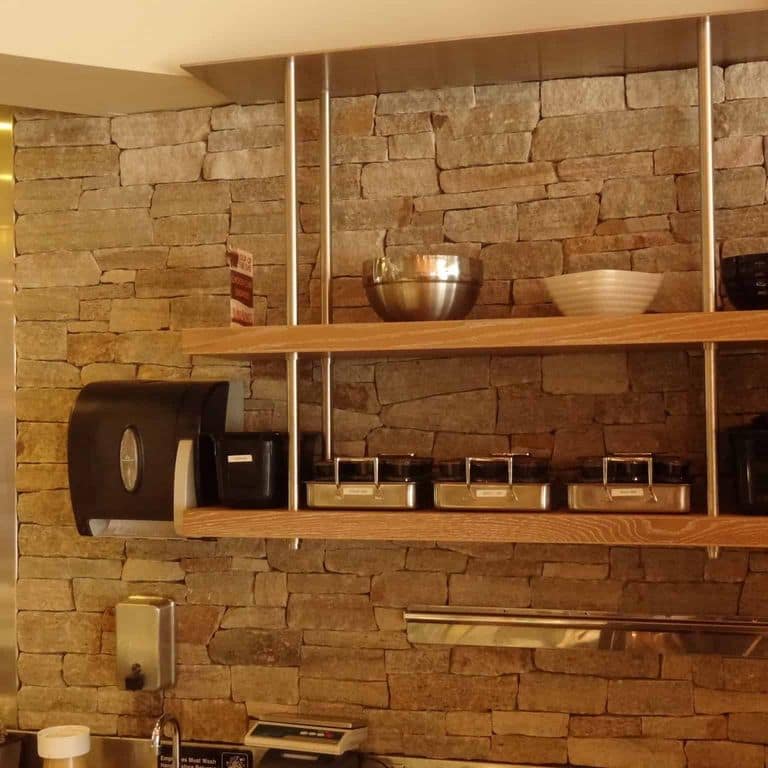 Application image for New England Tan Granite Veneer - Ledge. The image shows this product being used in a thin veneer application. The surface finish shown is split-face. Dominant colors shown are brown and tan. The color mix creates a warm feeling.