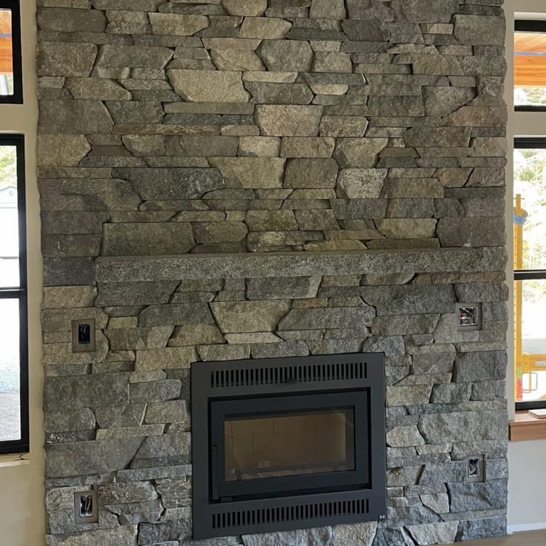 Application image for Rocky Mountain Granite - Veneer. The image shows this product being used in a full bed veneer application. The surface finish shown is split-face. The dominant color shown is gray. The color mix creates a warm feeling.