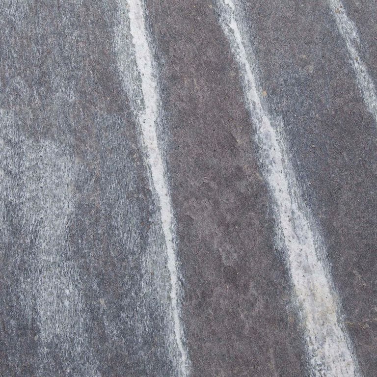Color/Finish variation image for Granite - Mystic Mountain- Dimensional Cut Pavers. Dominant colors shown are gray and purple; with blue, green and white secondaries. Exhibits "movement" and the color mix creates a cool feeling. Fine speckled, blotched and linear color patterns.