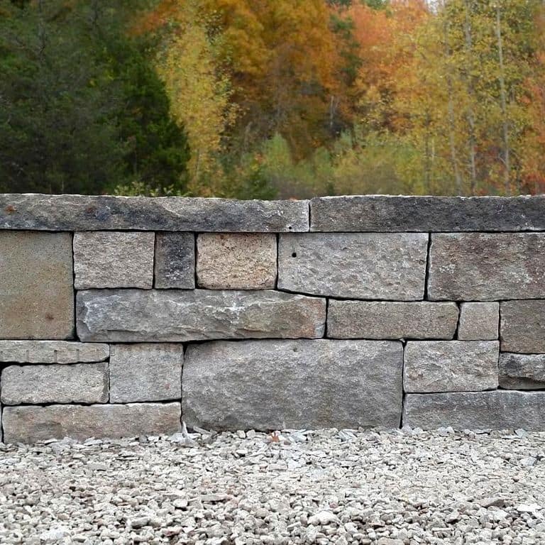 Application image for Test Record - Reclaimed Granite - Wallstone. The image shows this product being used for wallstone cap, landscape wallstone, columns and posts.