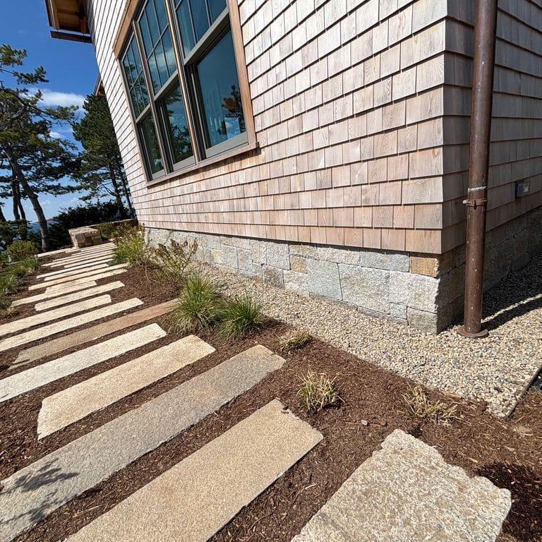 Application image for Test Record - Reclaimed Footworn Granite - Steppers. The image shows this product being used in a path pavers application. The surface finish shown is . The dominant color shown is tan.