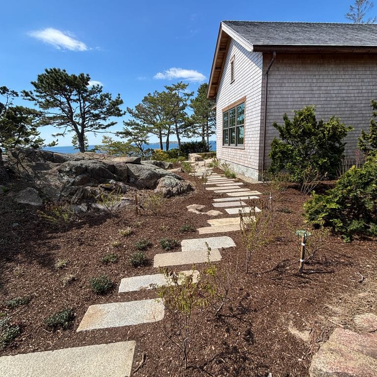 Application image for Test Record - Reclaimed Footworn Granite - Steppers. The image shows this product being used in a path pavers application. The surface finish shown is . The dominant color shown is tan.