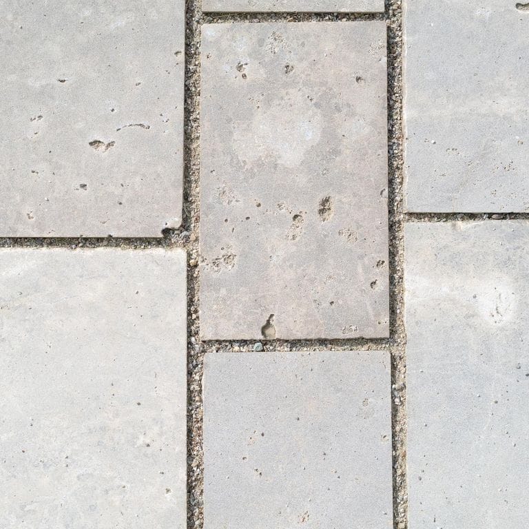 Best close-up image for Bavarian Dolomite Gray Limestone - Sandblasted Cobblestones. The surface finish shown is sand blasted. The dominant color shown is gray. The color mix creates a warm feeling.