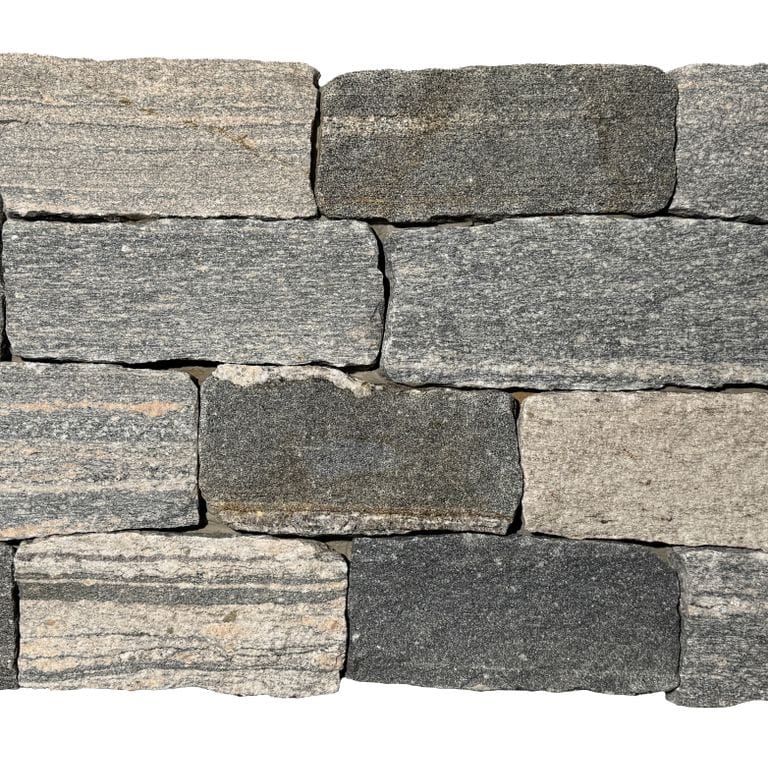 Feature image for Mystic Harbor Granite - Ashlar. The surface finish shown is split-face. The dominant color shown is gray. The color mix creates a warm feeling.