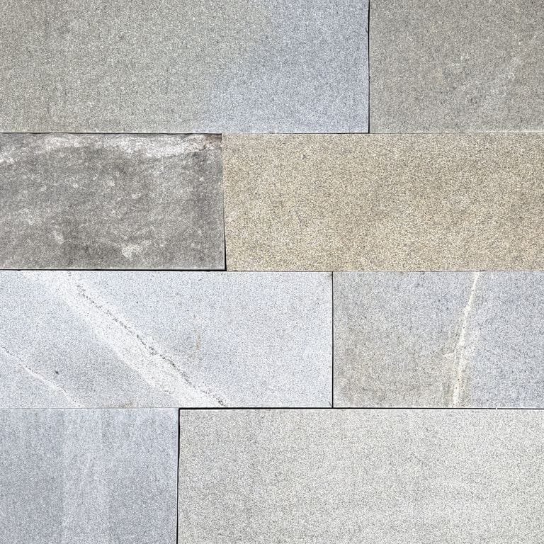 Color/Finish variation image for Heritage Plank Granite - Full Color - Planks. The surface finish shown is split-face. Dominant colors shown are gray and greige. The color mix creates a cool feeling.