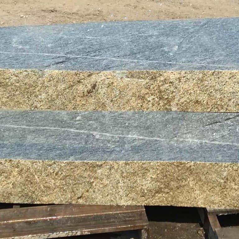 Close-up image for New England Fieldstone Boulders - Sawn Steps. The surface finish shown is sawn. The dominant color shown is gray; with blue, brown, green, white and tan secondaries. Exhibits "movement" and the color mix creates a cool feeling. Speckled, blotched and veined color patterns. Contains mineral inclusions.