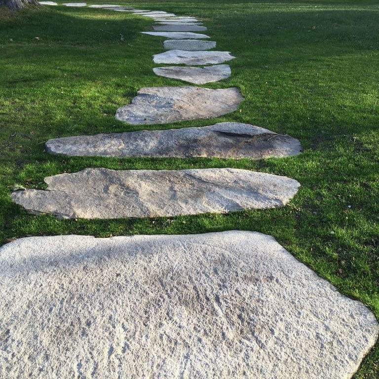 Application image for New England Fieldstone - Natural Surface Irregular Pavers. The image shows this product being used in a path pavers application. The dominant color shown is gray.