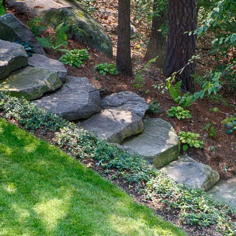 Application image for New England Fieldstone Steppers and Steps. The image shows this product being used in a monolithic steps application. This is a landscape stone for outdoor commercial and residential applications. Suitable for general use, freeze-thaw conditions, high traffic areas and low slipperiness surfaces situations. Moderate to higher on the price spectrum.