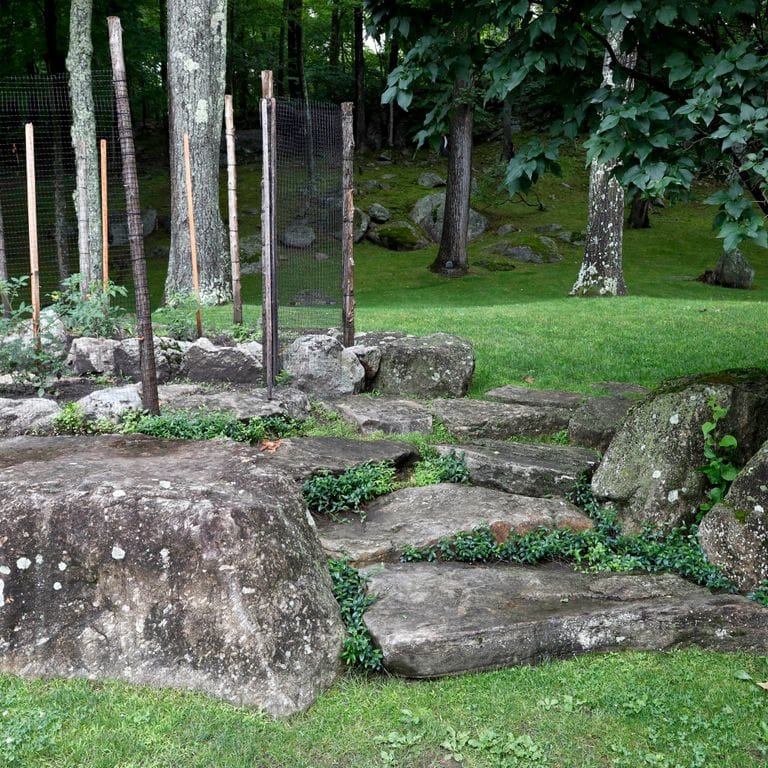 Application image for New England Fieldstone - Steps and Landings. The image shows this product being used in a monolithic steps application. Dominant colors shown are black and gray.