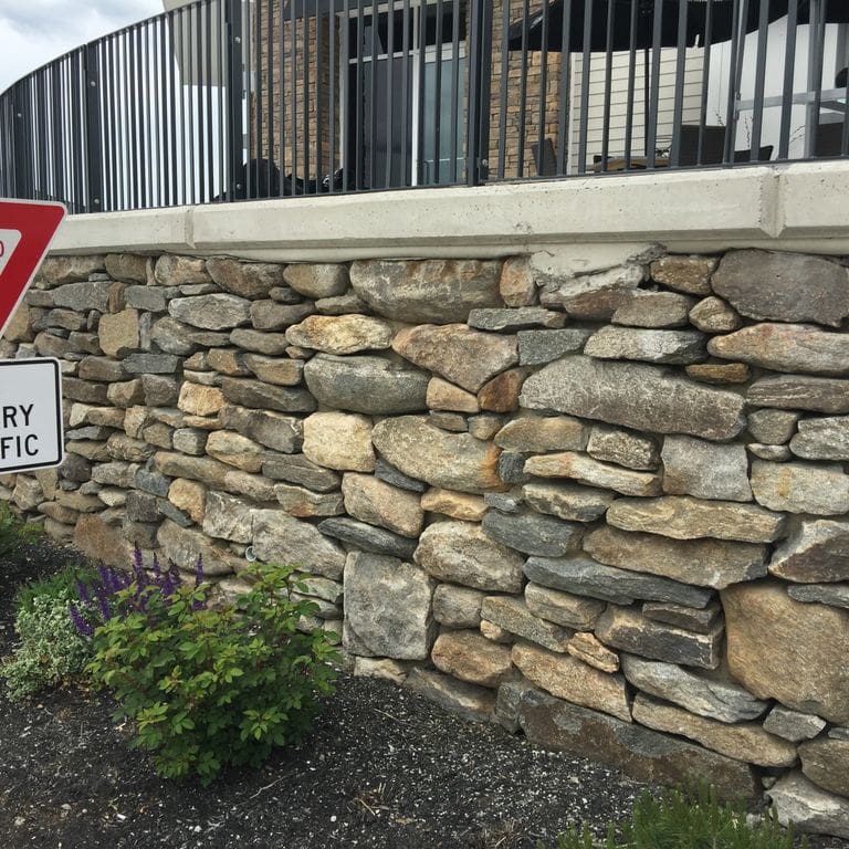 The image shows this product being used in a landscape wallstone application.