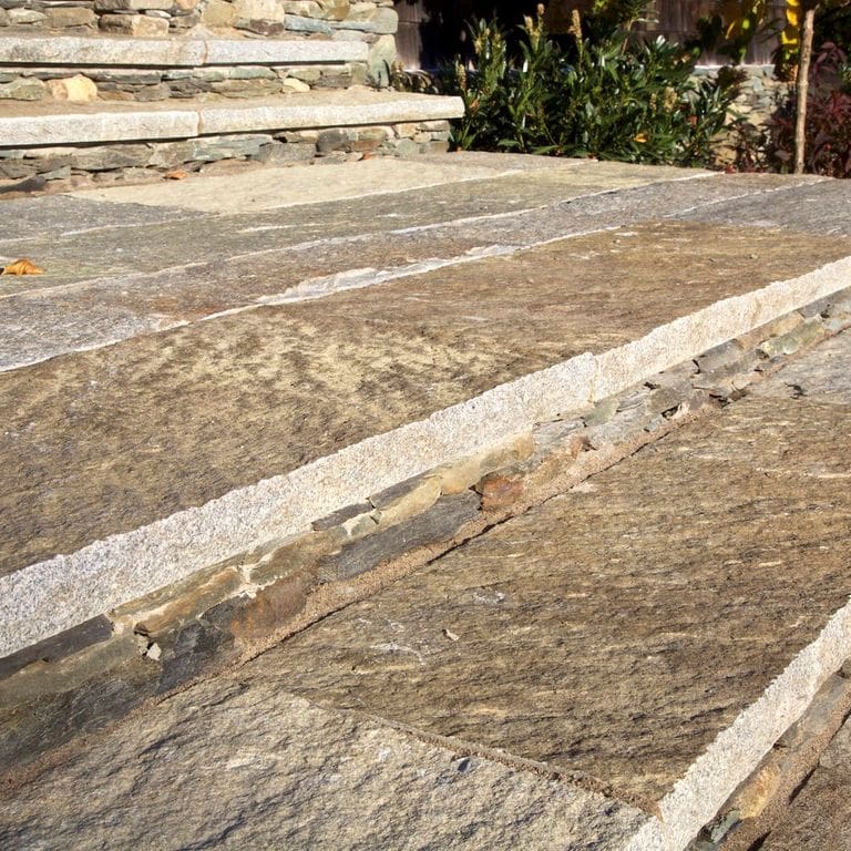 Best close-up image for Reclaimed Granite Plank Pavers - Sawn Edge. The image shows this product being used for landings and treads. The surface finish shown is . Dominant colors shown are beige, brown and tan; with gray, orange/rust and cream secondaries. Exhibits "movement" and the color mix creates a warm feeling. Streaked, swirled, speckled, blotched and random color patterns.