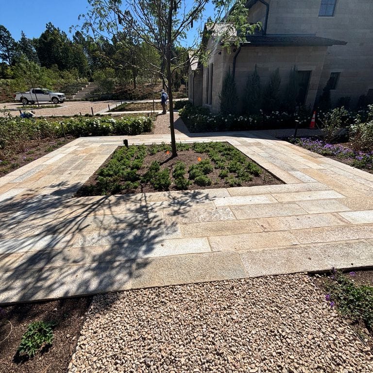 Application image for Reclaimed Footworn Granite - Plank Pavers. The image shows this product being used in a patio pavers application. The surface finish shown is . Dominant colors shown are beige and tan. The color mix creates a warm feeling.