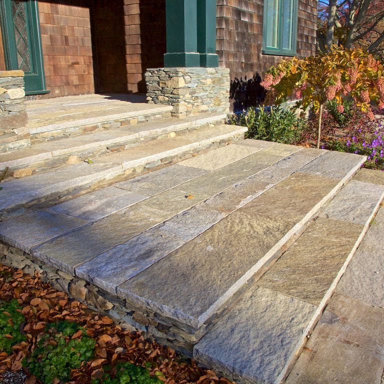 Application image for Reclaimed Granite Treads - Weathered Riser and Tread. The image shows this product being used in a treads application. This is a landscape stone for indoor and outdoor commercial and residential applications. Suitable for general use, freeze-thaw conditions, low heat absorption surfaces, high traffic areas, low slipperiness surfaces and high heel compatibilty situations. Higher to high on the price spectrum.
