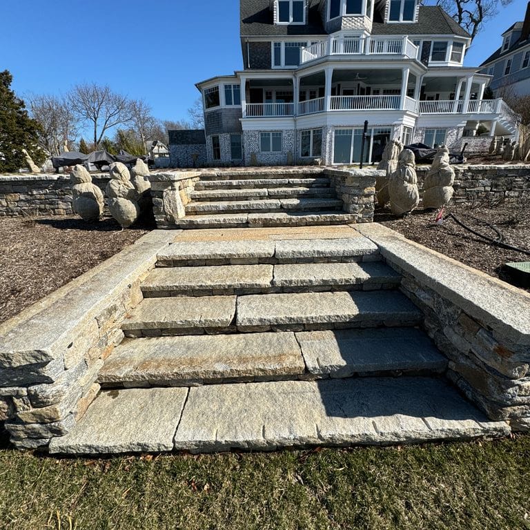Application image for Reclaimed Granite Treads - Weathered Riser and Tread. The image shows this product being used in a treads application. Dominant colors shown are blue and gray. The color mix creates a cool feeling.