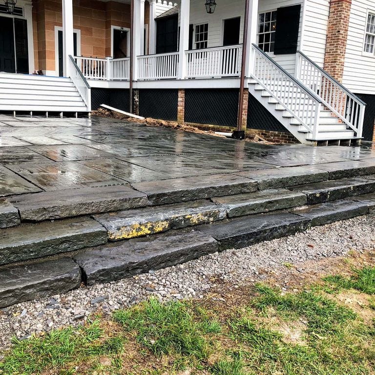 Application image for Reclaimed Bluestone Curbstone Steps - Weathered Riser and Tread. The image shows this product being used in a monolithic steps application. This is a landscape stone for outdoor commercial and residential applications. Suitable for general use, freeze-thaw conditions, low heat absorption surfaces, high traffic areas, low slipperiness surfaces and high heel compatibilty situations. Higher to high on the price spectrum.