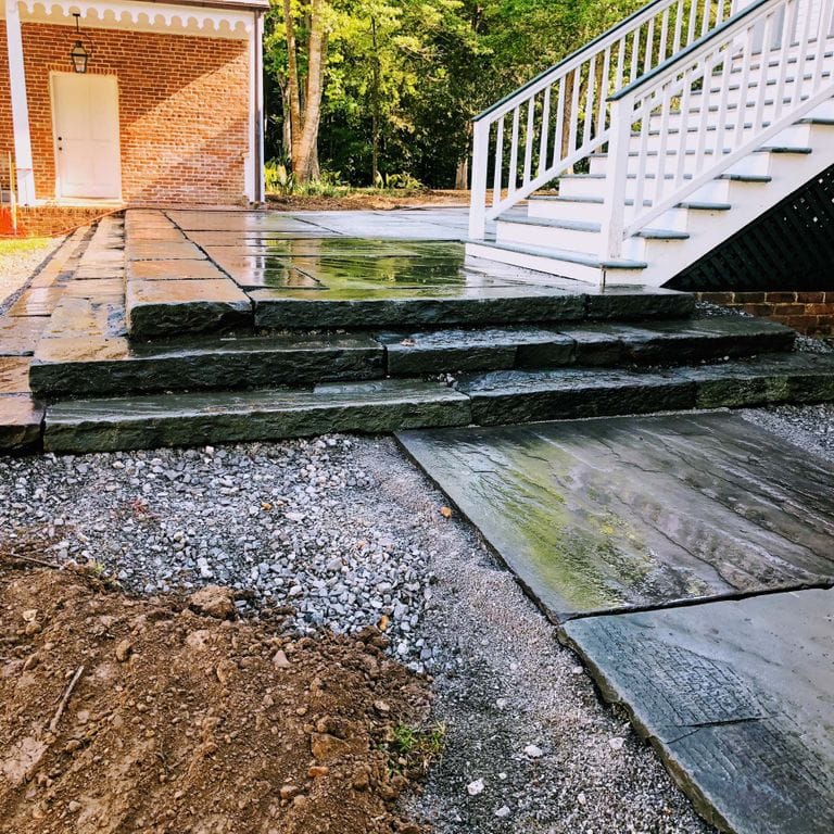 Application image for Reclaimed Bluestone Curbstone Steps - Weathered Riser and Tread. The image shows this product being used in a monolithic steps application. This is a landscape stone for outdoor commercial and residential applications. Suitable for general use, freeze-thaw conditions, low heat absorption surfaces, high traffic areas, low slipperiness surfaces and high heel compatibilty situations. Higher to high on the price spectrum.