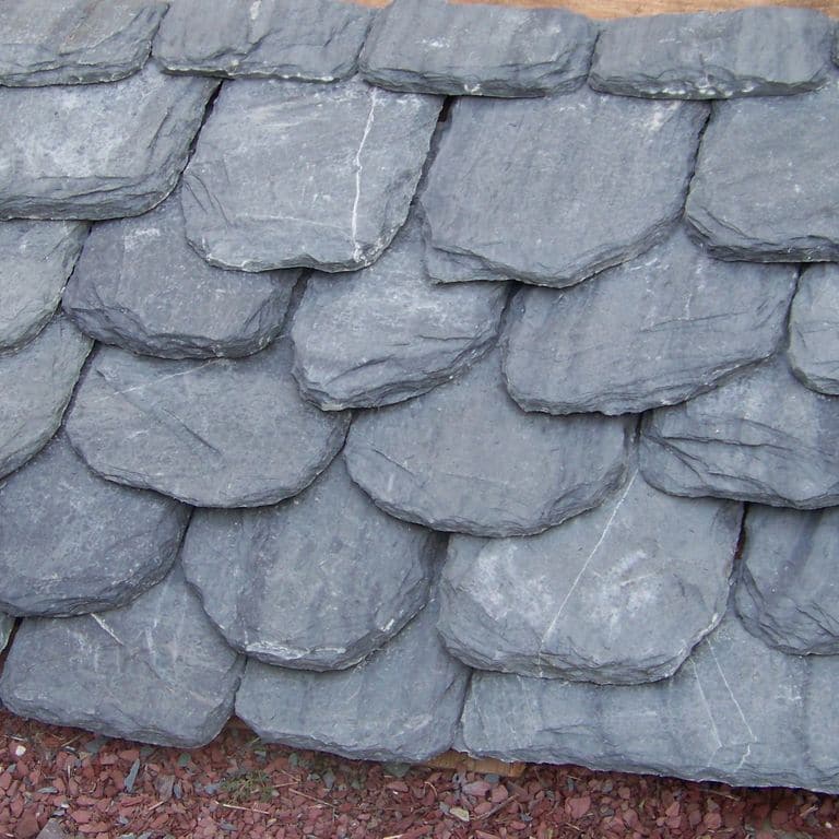 Best close-up image for Vermont Slate Striated Gray - Roof Shingles. The image shows this product being used in a Roof Shingles application. The surface finish shown is natural cleft. Dominant colors shown are blue and gray; with a white secondary. Exhibits "movement" and the color mix creates a cool feeling. Linear, streaked and blotched color patterns.