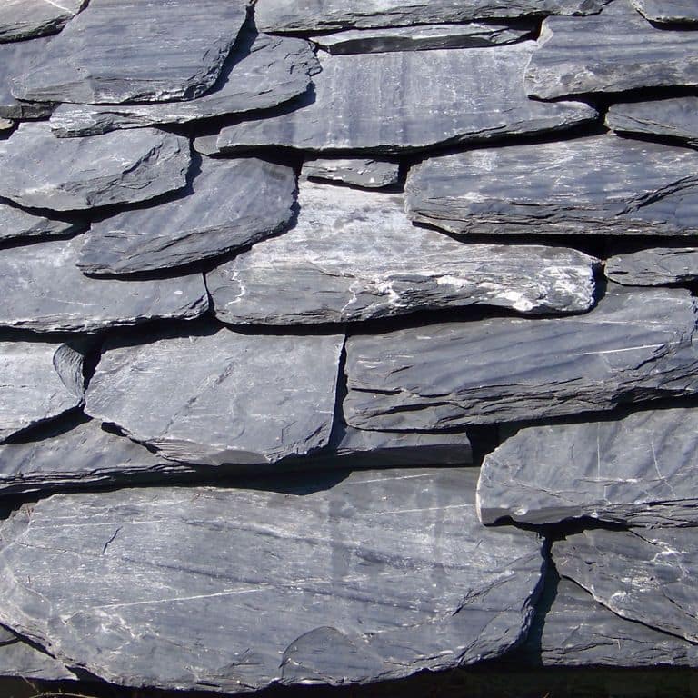 Application image for Vermont Slate Striated Gray - Roof Shingles. The image shows this product being used in a Roof Shingles application. The surface finish shown is natural cleft. Dominant colors shown are blue and gray; with a white secondary. Exhibits "movement" and the color mix creates a cool feeling. Regular, linear and streaked color patterns.