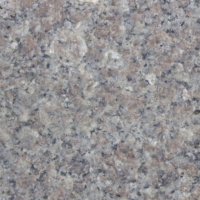 Color/Finish variation image for Reclaimed Granite Curbstone - Pool Coping. The dominant color shown is gray; with black, green, purple and white secondaries. The color mix creates a cool feeling. Coarse speckled color pattern. Contains some mica and mineral inclusions.