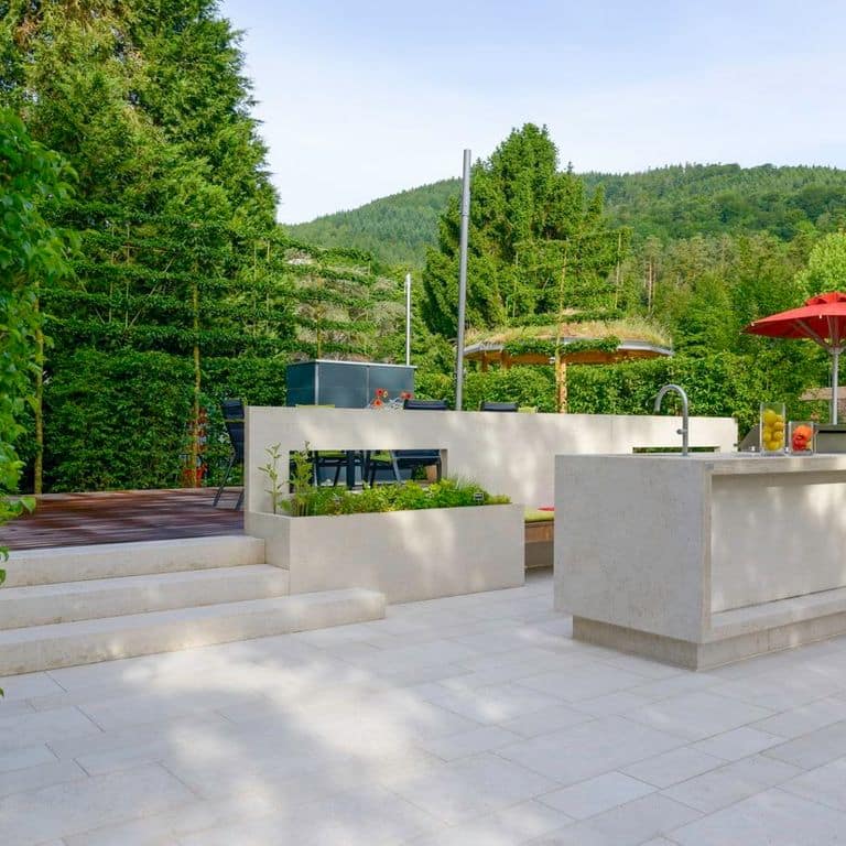 Application image for Mountain Hard Limestone Beige - Dimensional Cut Pavers. The image shows this product being used in a patio pavers application. Dominant colors shown are blue and gray. The color mix creates a cool feeling.