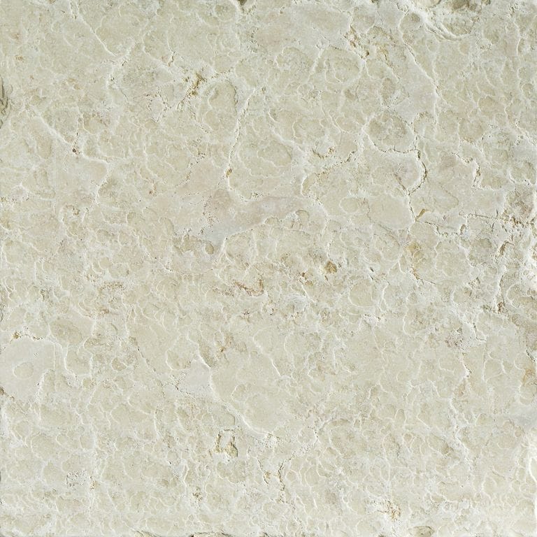 Swatch image cropped for Mountain Hard Limestone Beige - Cobblestone Pavers. The surface finish shown is flamed. Dominant colors shown are beige and cream; with gray, white and tan secondaries. Exhibits "movement" and the color mix creates a warm feeling. Regular, blotched and cloudy color patterns.