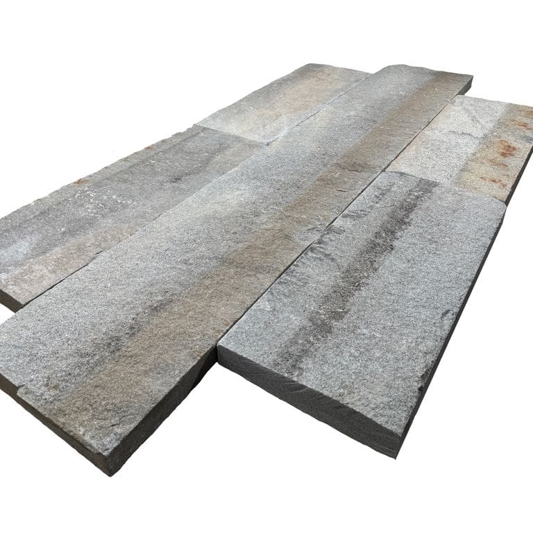 Oblique image for Reclaimed Third Generation Granite Curbstone - Plank Pavers. The surface finish shown is . The dominant color shown is gray. The color mix creates a warm feeling.