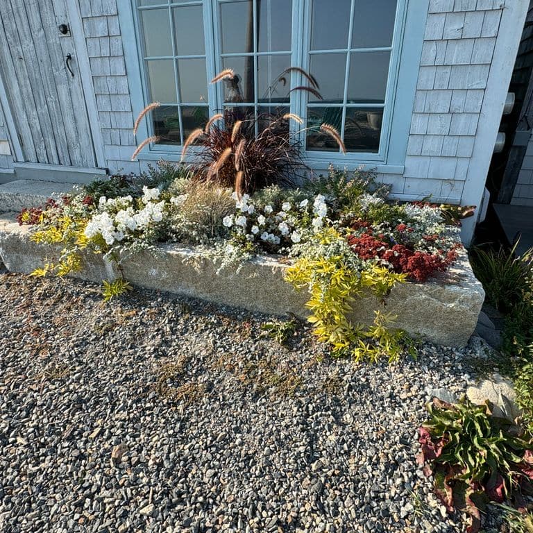 Application image for Granite - Reclaimed First Generation Curbstone - Edging. The image shows this product being used in a landscape curbing &amp; edging application. The surface finish shown is . The dominant color shown is gray.