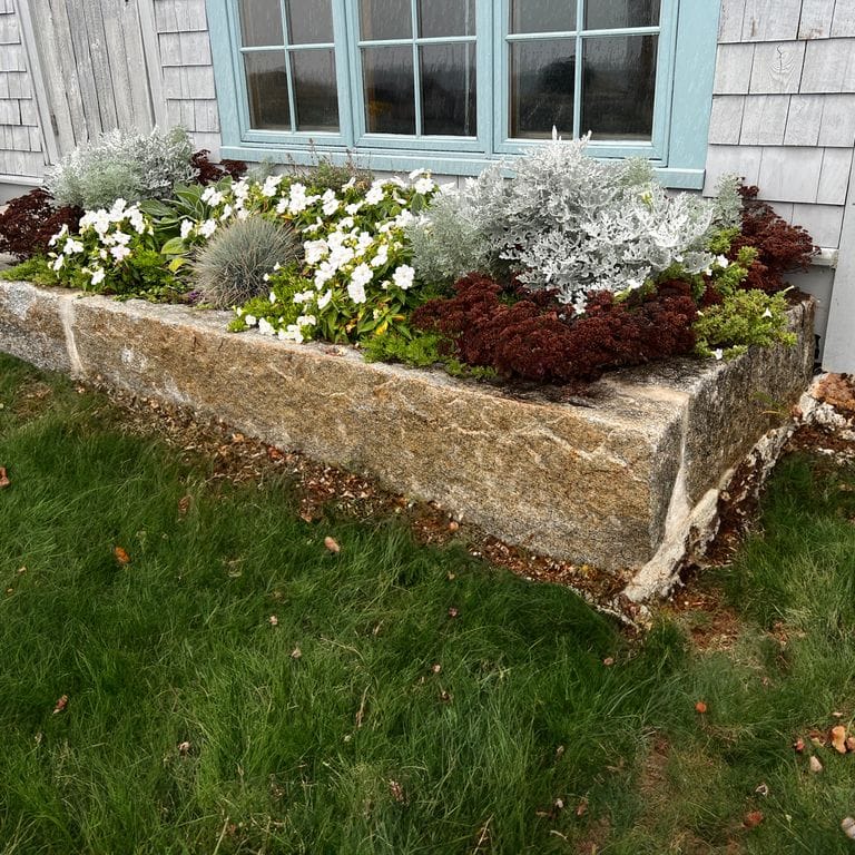 Application image for Reclaimed First Generation Curbstone - Edging. The image shows this product being used in a landscape curbing &amp; edging application. The surface finish shown is . Dominant colors shown are brown and gray. The color mix creates a warm feeling.