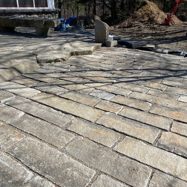 The image shows this product being used for driveway pavers and patio pavers.