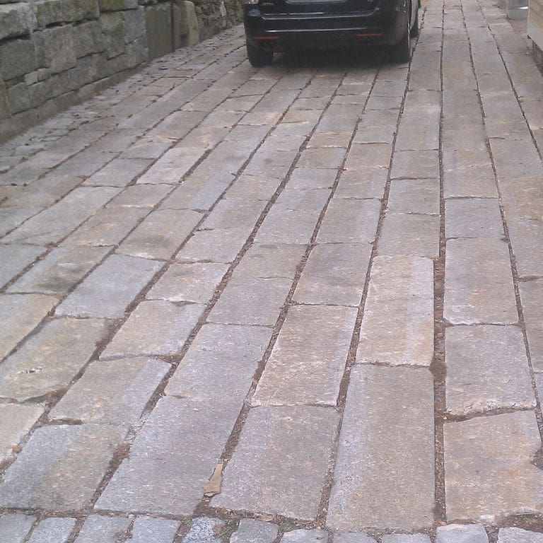 The image shows this product being used in a driveway pavers application.