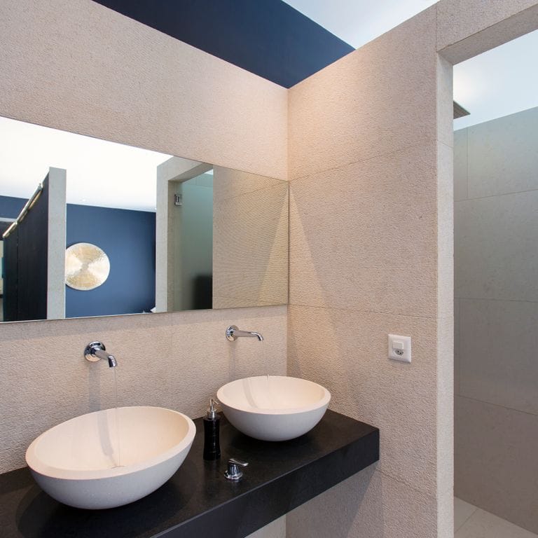Application image for Mountain Hard Limestone Beige - Wall Veneer. The image shows this product being used in a bath tub &amp; shower application. This is a building stone for indoor and outdoor commercial and residential applications. Suitable for general use, freeze-thaw conditions and low heat absorption surfaces situations. Moderate to high on the price spectrum.