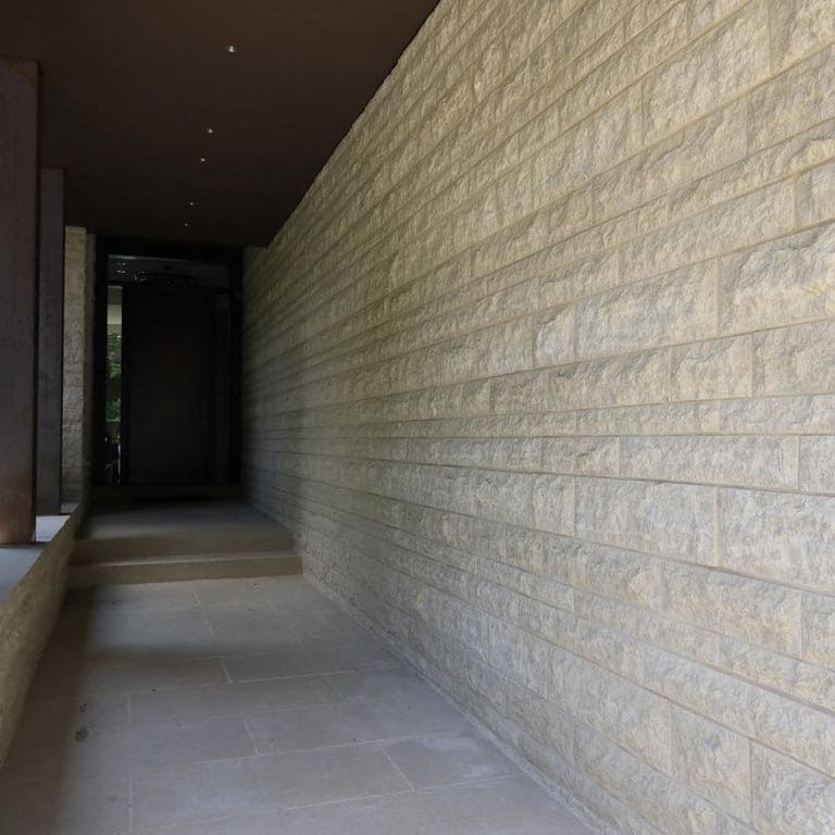 Application image for Mountain Hard Beige Limestone - Cut to Size Veneer. The image shows this product being used in a full bed veneer application. The surface finish shown is split-face. The dominant color shown is beige. The color mix creates a warm feeling.