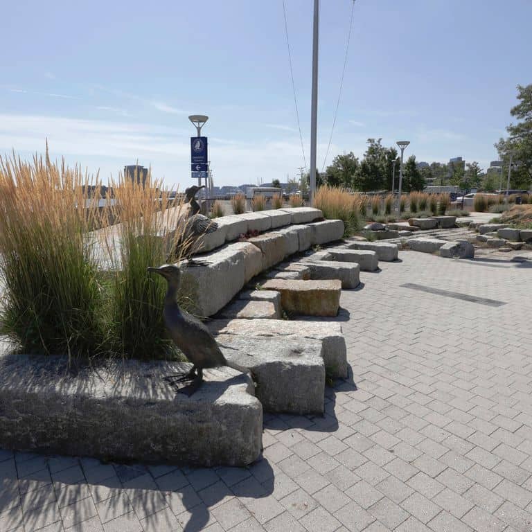 Application image for Granite - Reclaimed Block - Benches. The image shows this product being used in a seating &amp; benches application. The surface finish shown is weathered. The dominant color shown is gray. The color mix creates a warm feeling.