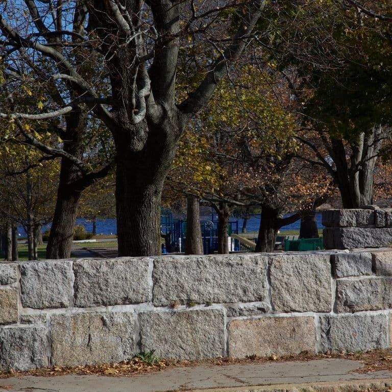 Application image for Granite - Reclaimed Block Wallstone - Block Mix. The image shows this product being used in a landscape wallstone application.