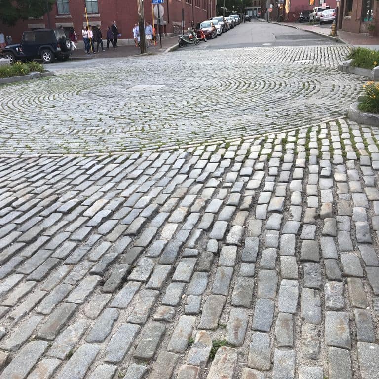 The image shows this product being used in a driveway pavers application.