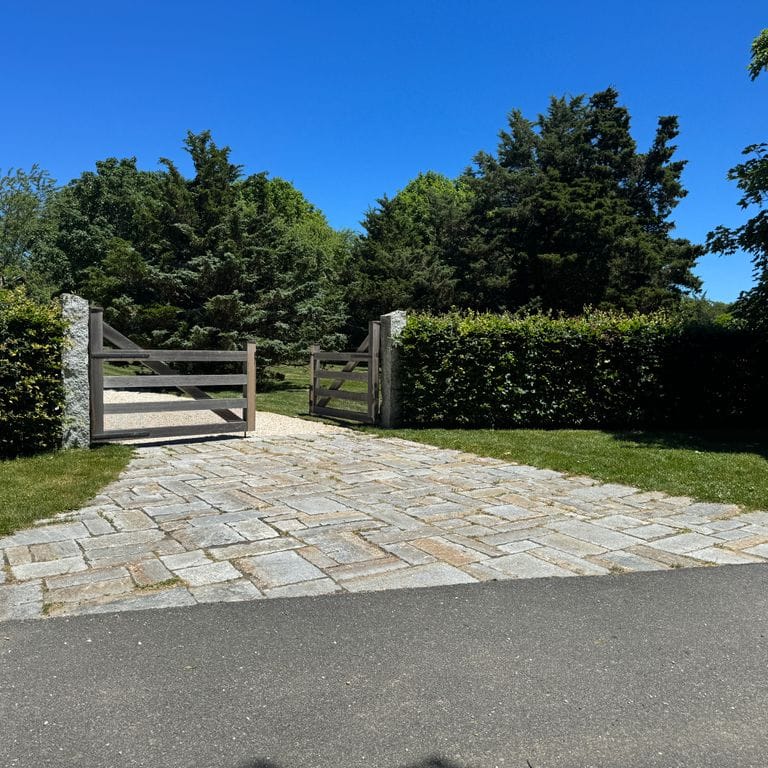 Application image for Reclaimed New England Cobblestones - Super Jumbo Pavers. The image shows this product being used in a driveway aprons application. The surface finish shown is . The dominant color shown is gray.