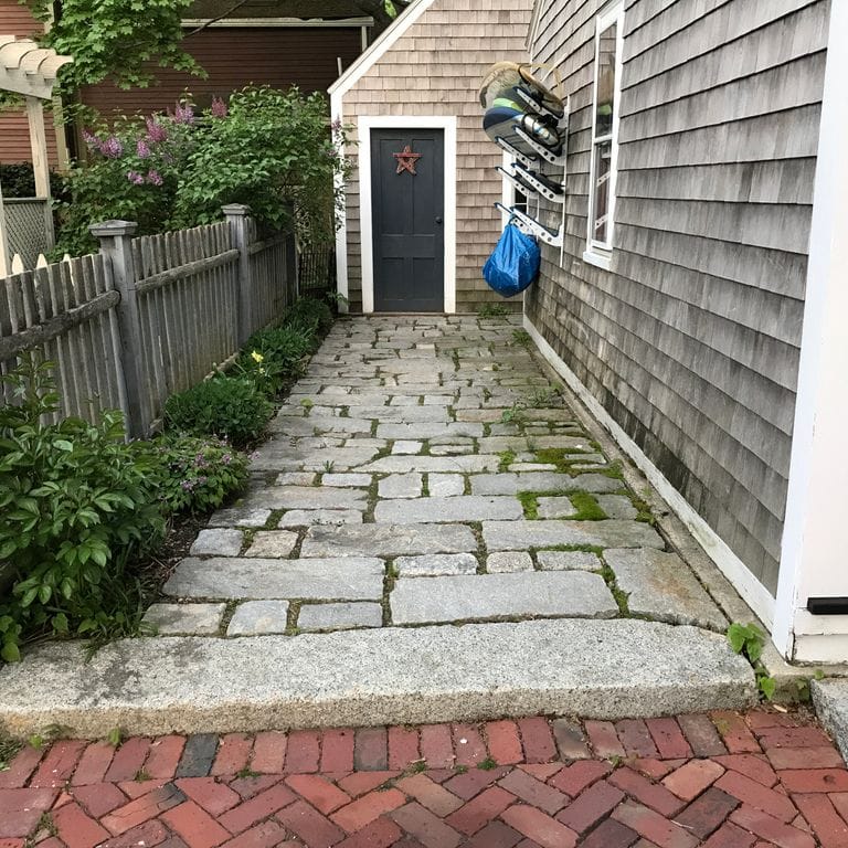 Application image for Granite - Reclaimed New England Cobblestones - Super Jumbo Pavers. The image shows this product being used in a path pavers application. The surface finish shown is . The dominant color shown is gray.