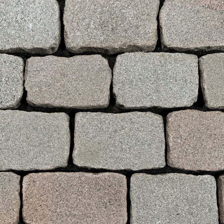 Color/Finish variation image for Reclaimed Swedish Granite Cobblestones - Flat Surface. The surface finish shown is flamed. The dominant color shown is gray. The color mix creates a warm feeling.