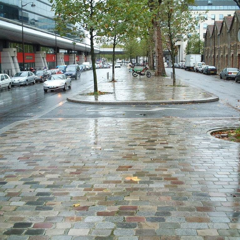 Application image for Granite - Reclaimed Swedish Cobblestones - Flat Surface. The image shows this product being used in a public area application. The dominant color shown is gray.