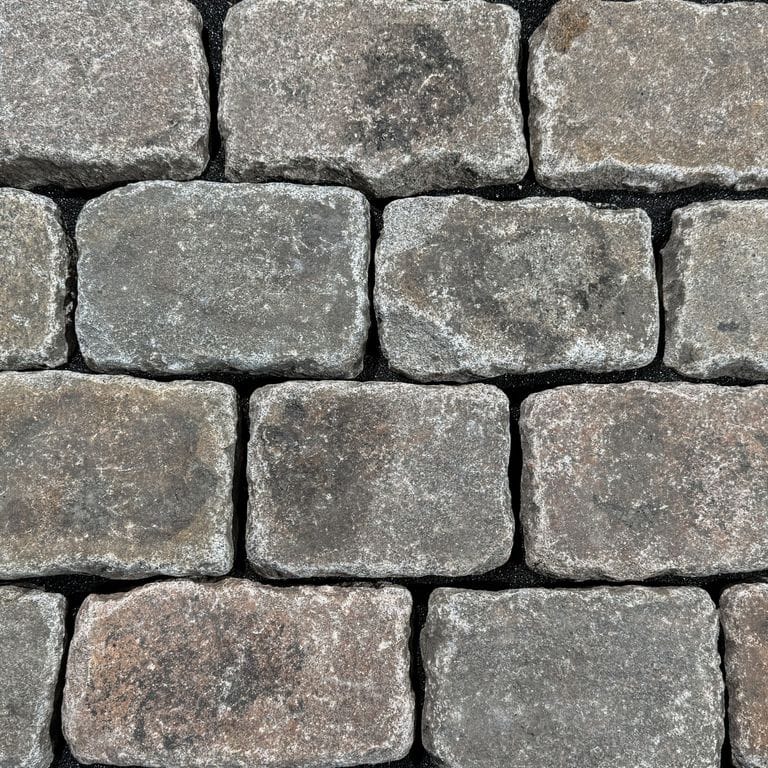 Color/Finish variation image for Reclaimed Swedish Granite Cobblestones - Worn Surface. The surface finish shown is . Dominant colors shown are gray and tan. The color mix creates a warm feeling.