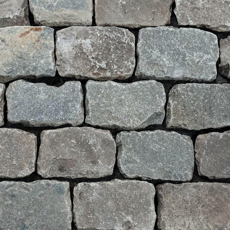 Color/Finish variation image for Reclaimed European Porphyry Cobblestones - Rectangle - Worn Surface. The surface finish shown is . The dominant color shown is gray.