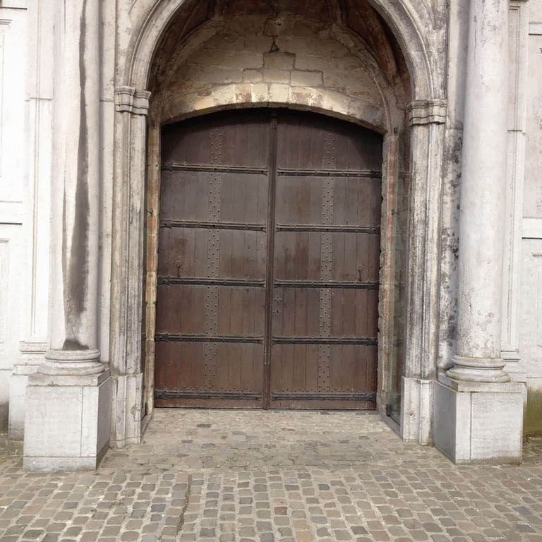 Application image for Sandstone - Reclaimed European Cobblestones - Rectangle - Flat Surface. The image shows this product being used for patio pavers and public area. Dominant colors shown are brown, gray and tan; with beige and cream secondaries. The color mix creates a warm feeling. Fine speckled color pattern.