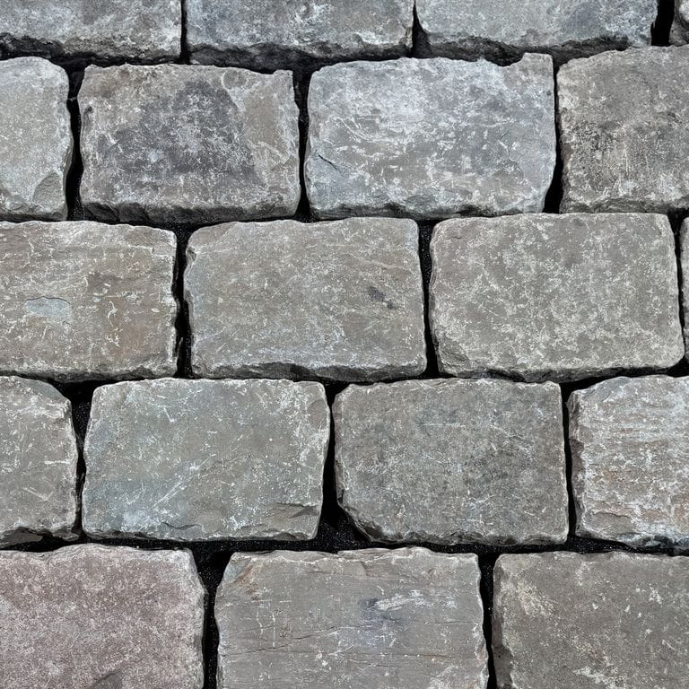 Color/Finish variation image for Reclaimed European Sandstone Cobblestones - Rectangle - Worn Surface. The surface finish shown is . The dominant color shown is gray. The color mix creates a cool feeling.
